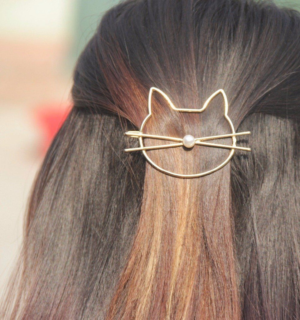 cat hair pin with brown hair zoomed in